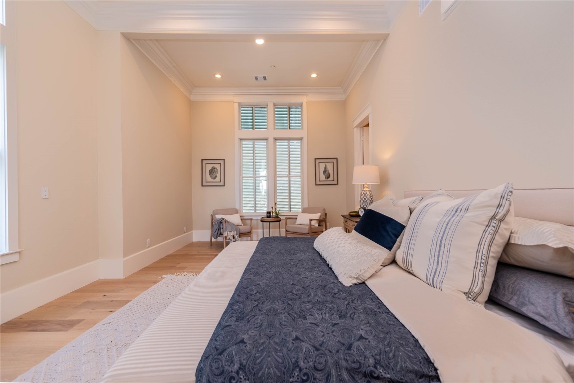 11610 Beachside Galveston, TX 77554 - Photo 24 of 50 a large bedroom with a bed and wooden floor
