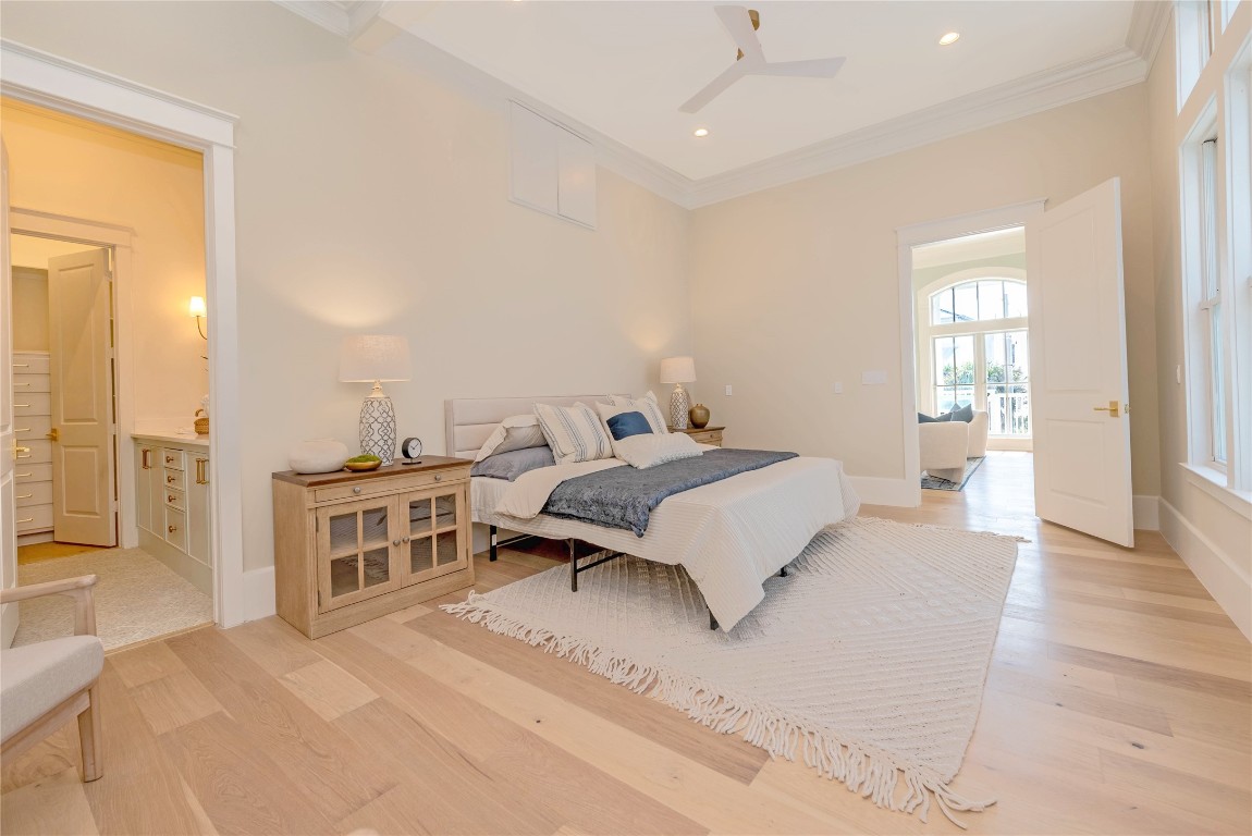 11610 Beachside Galveston, TX 77554 - Photo 25 of 50 a bedroom with a large bed and a chandelier