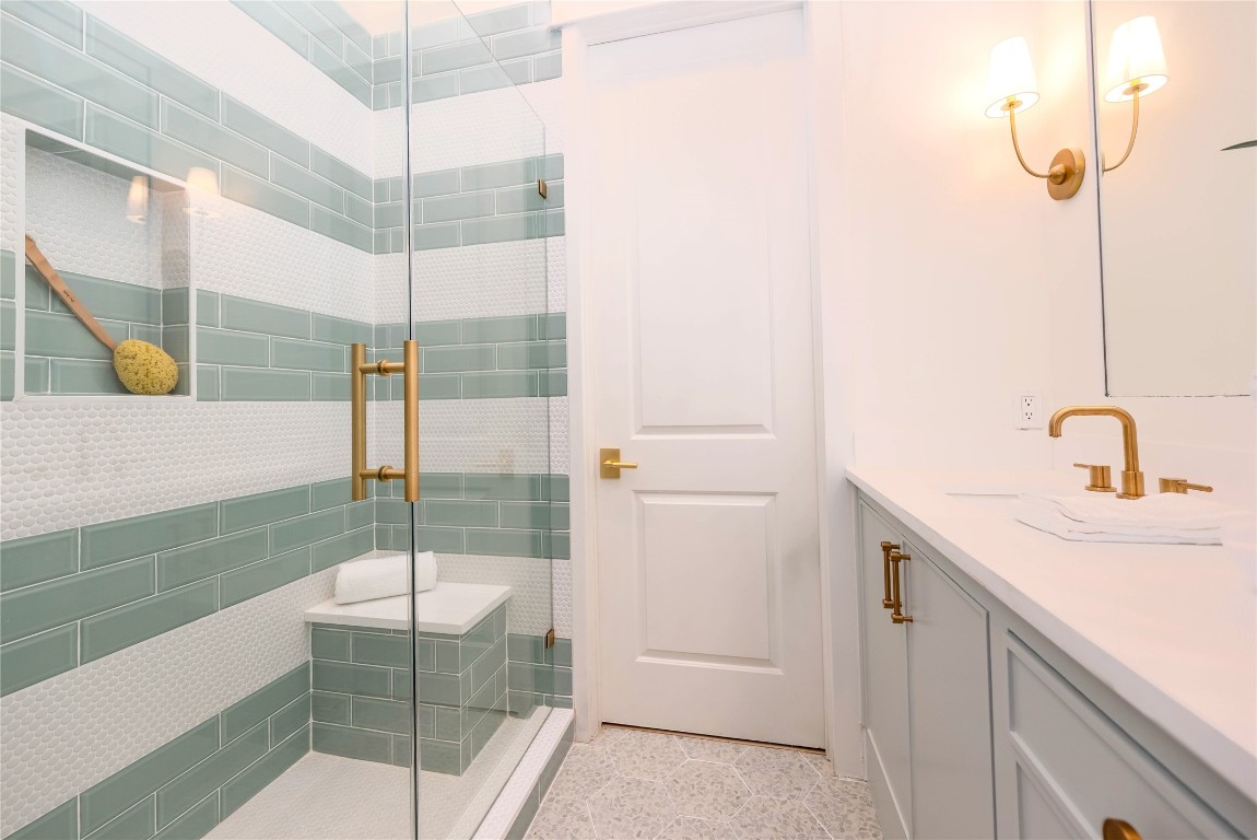 11610 Beachside Galveston, TX 77554 - Photo 27 of 50 a bathroom with a shower sink and mirror