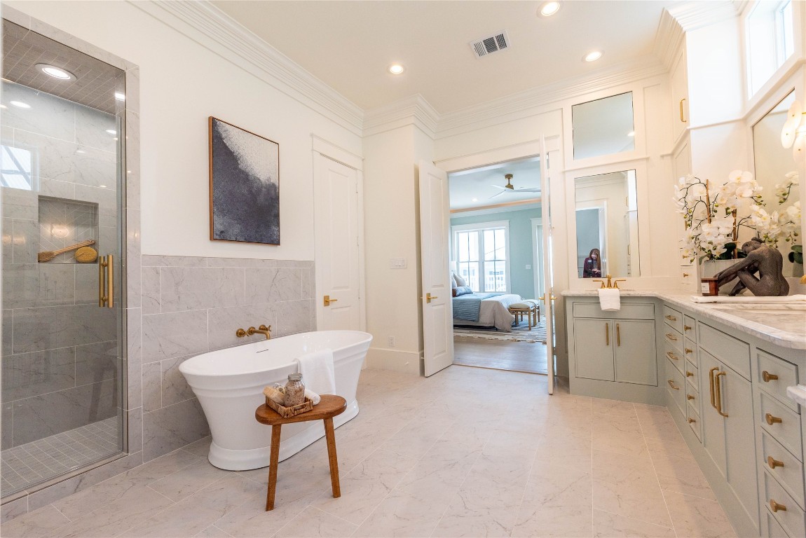 11610 Beachside Galveston, TX 77554 - Photo 38 of 50 a spacious bathroom with a tub sink and mirror