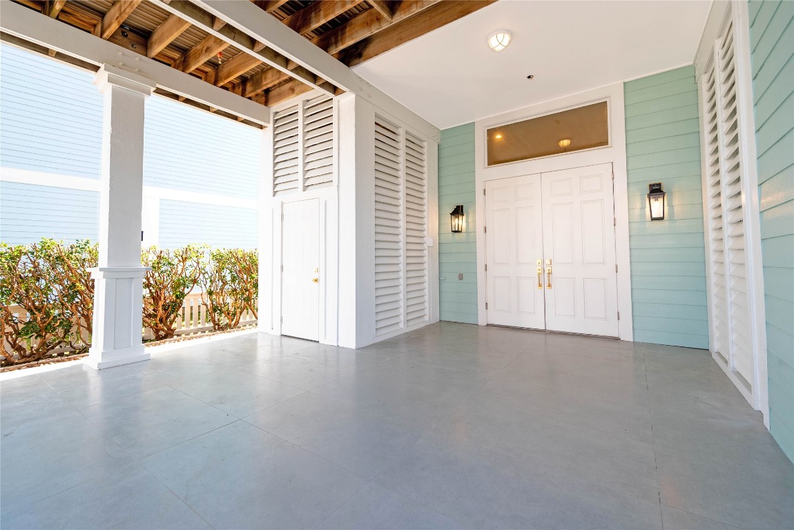 11610 Beachside Galveston, TX 77554 - Photo 5 of 50 an empty room with wooden floor and windows