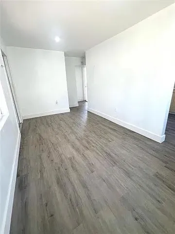 an empty room with wooden floor