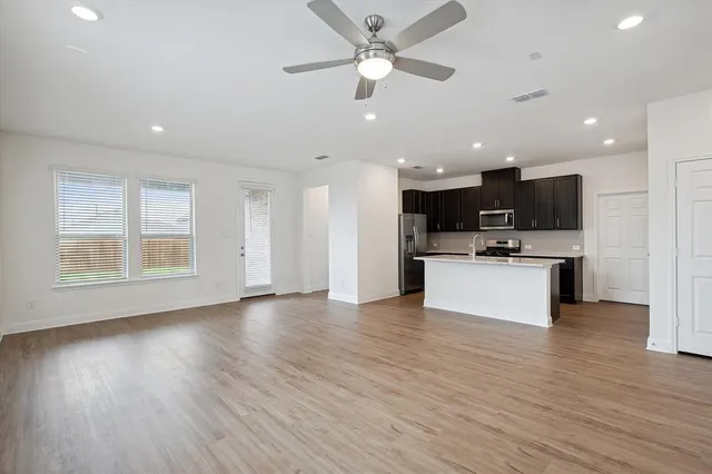 a view of kitchen with cabinets and wooden floor