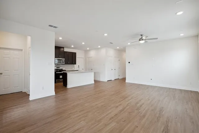 a view of kitchen with sink and refrigerator
