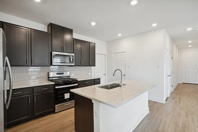 a kitchen with granite countertop a sink and cabinets