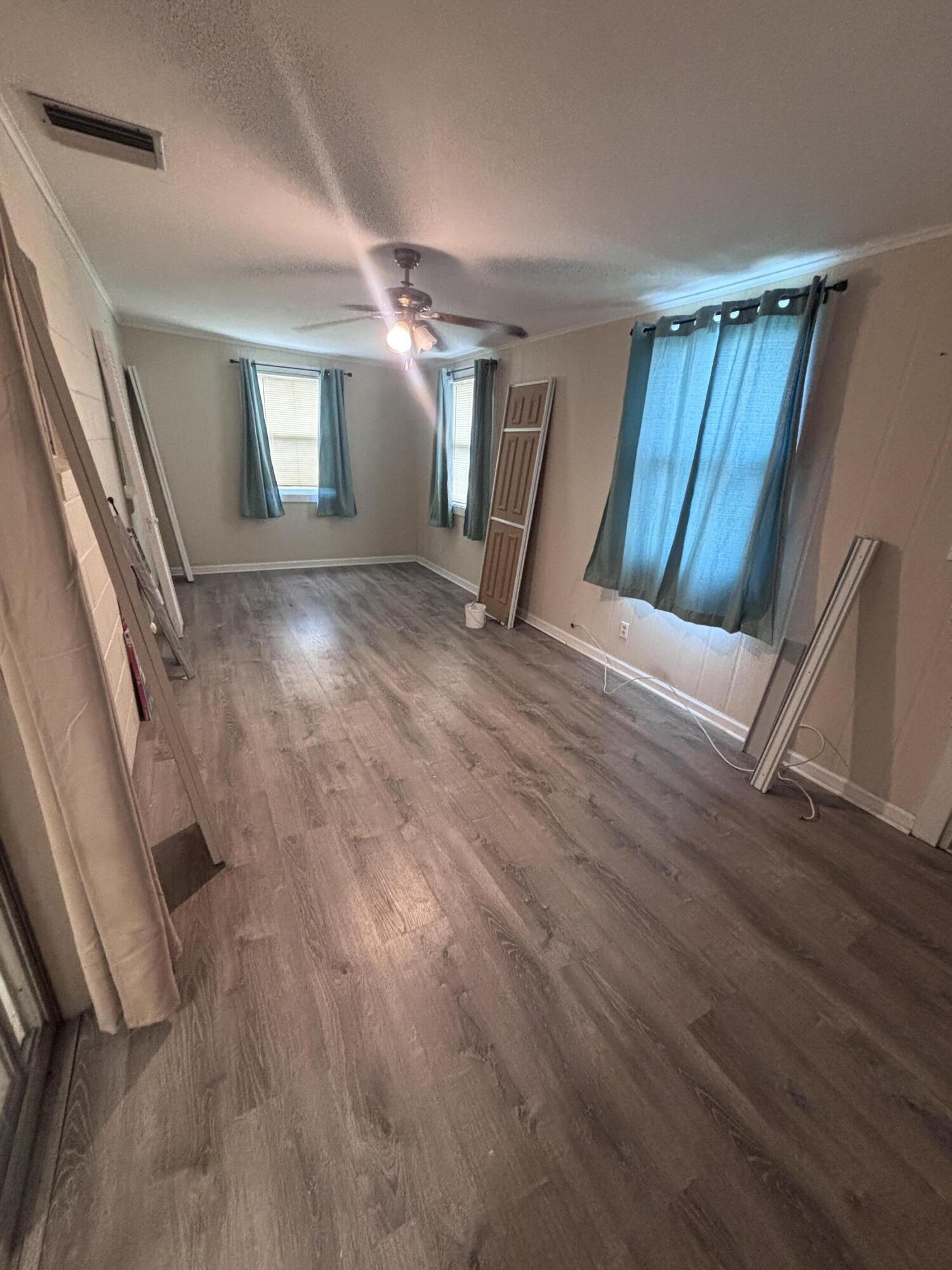 202 Balboa Street, Unit A Fort Pierce, FL 34949 - Photo 8 of 10 a view of a livingroom with wooden floor and staircase