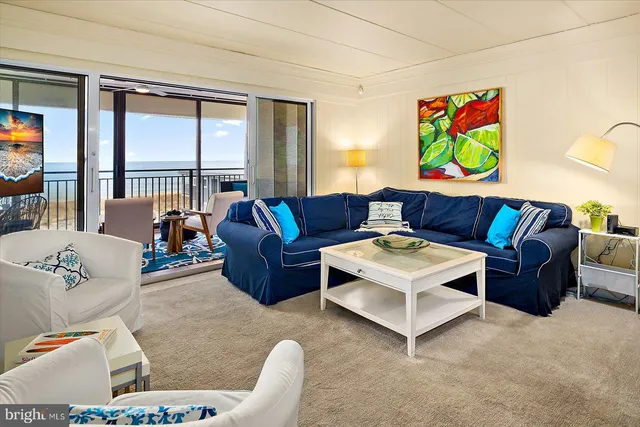 a kitchen with stainless steel appliances kitchen island granite countertop a table chairs and a refrigerator