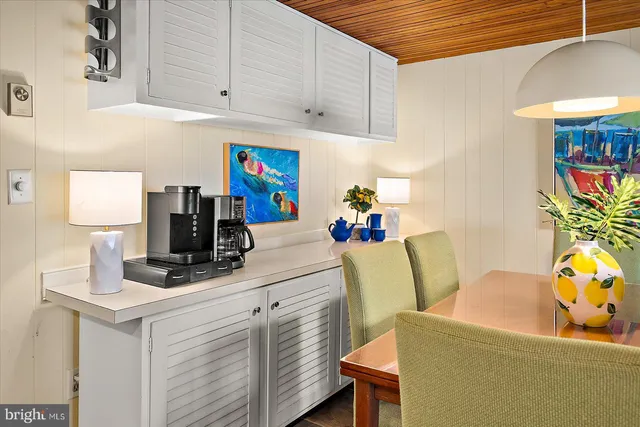 a dining room with furniture a rug and wooden floor