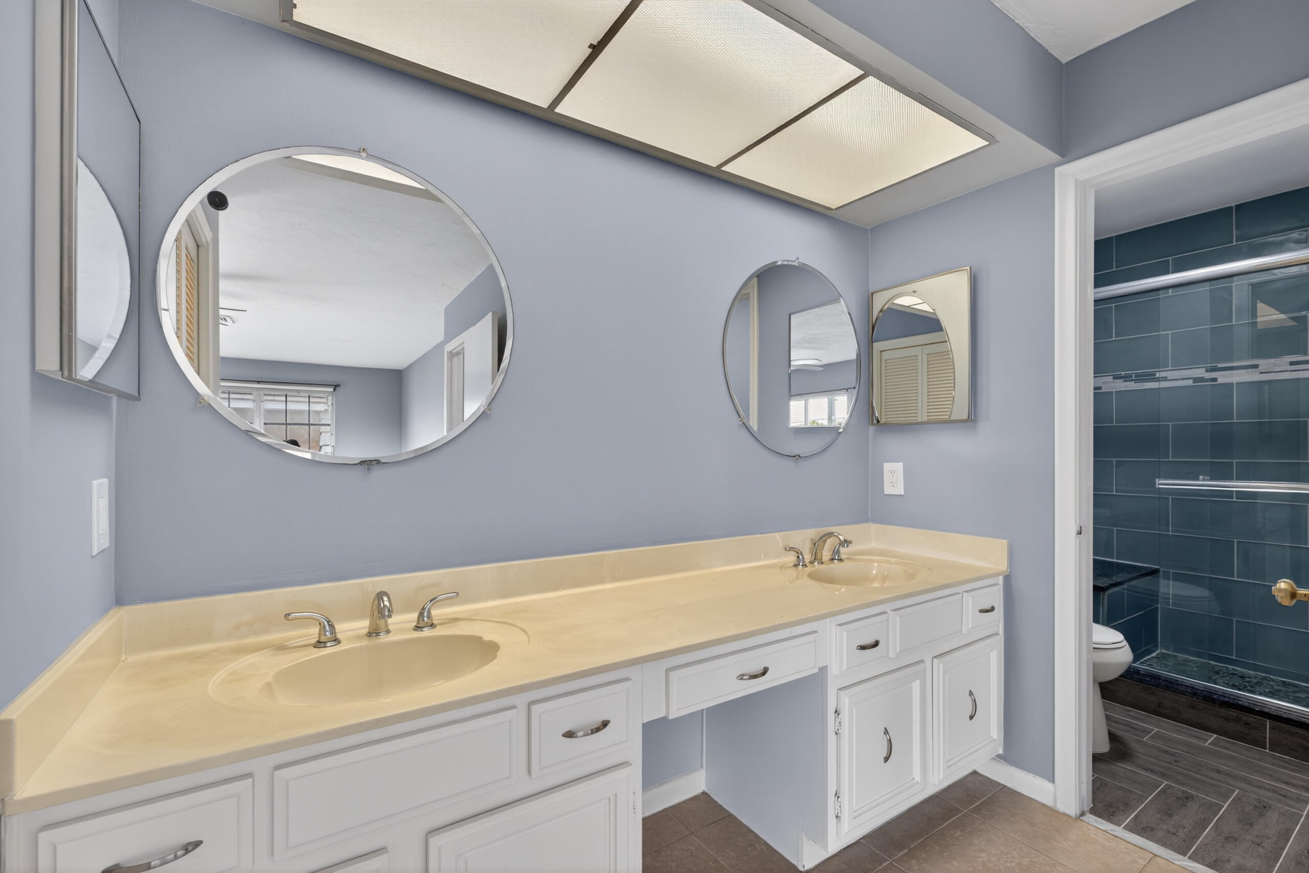 423 Pine Tree Court, Unit 23 Atlantis, FL 33462 - Photo 14 of 33 a spacious bathroom with a sink double vanity and a mirror