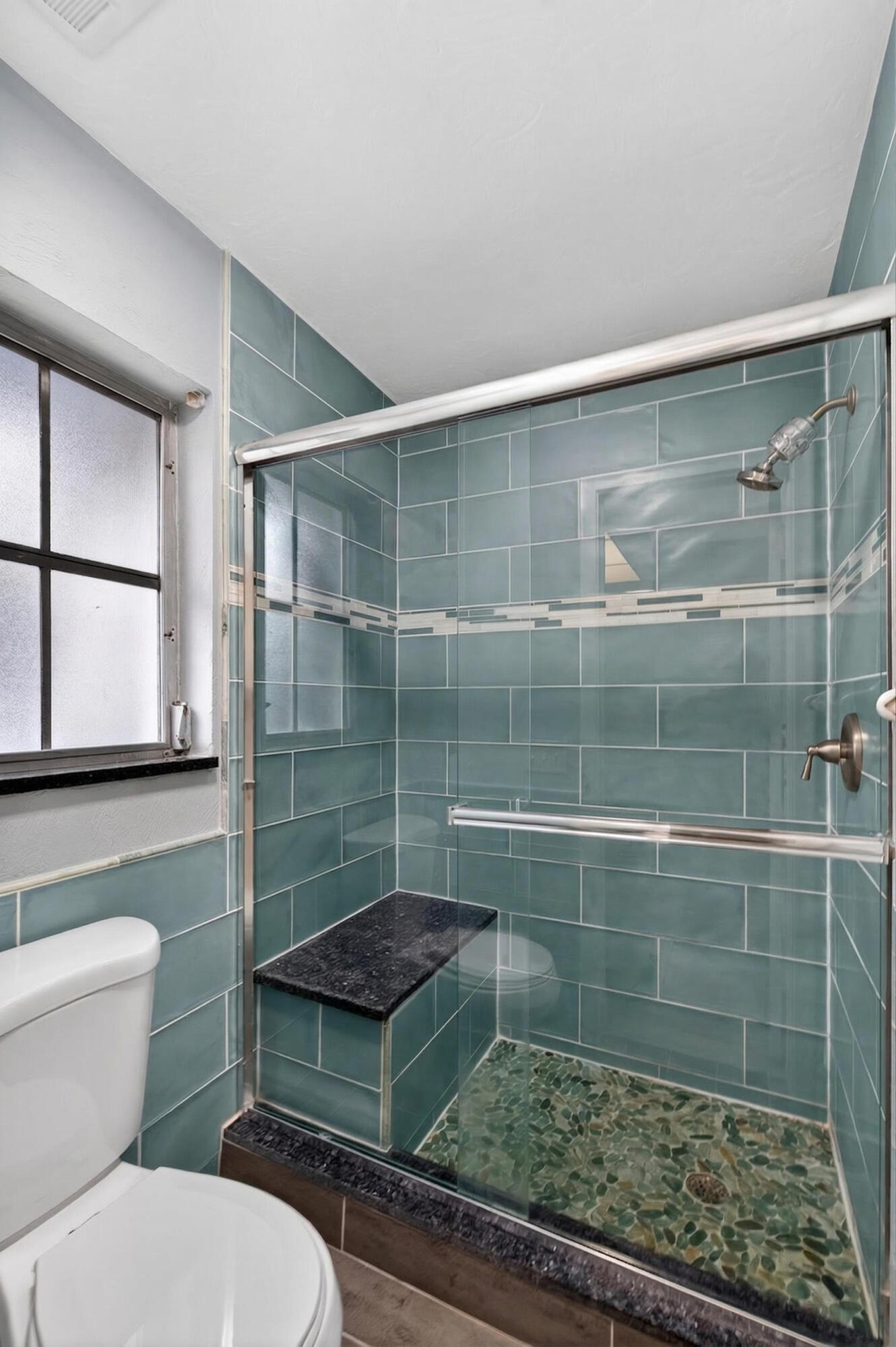 423 Pine Tree Court, Unit 23 Atlantis, FL 33462 - Photo 15 of 33 a bathroom with a toilet and a shower