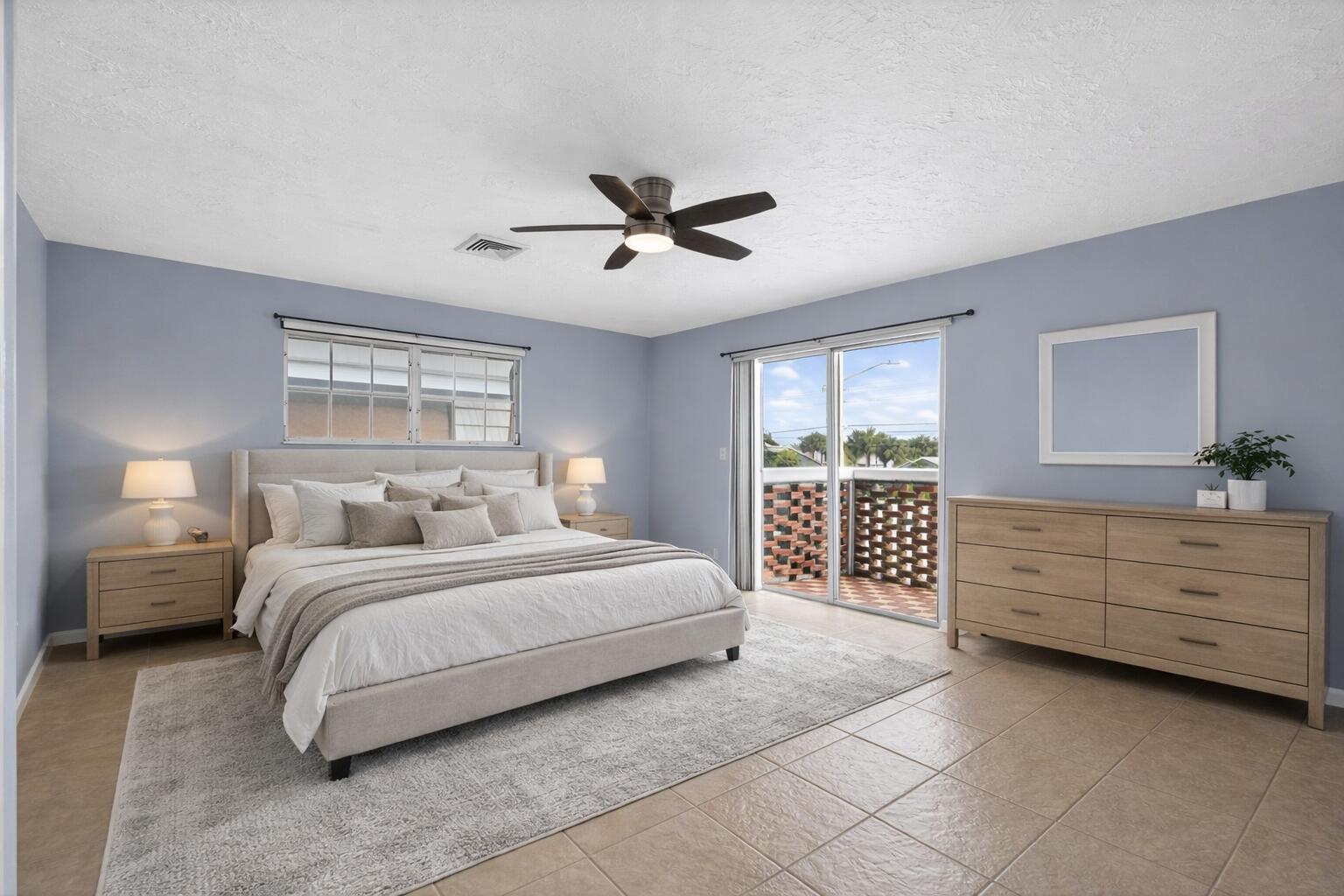423 Pine Tree Court, Unit 23 Atlantis, FL 33462 - Photo 17 of 33 a spacious bedroom with a large bed and a window