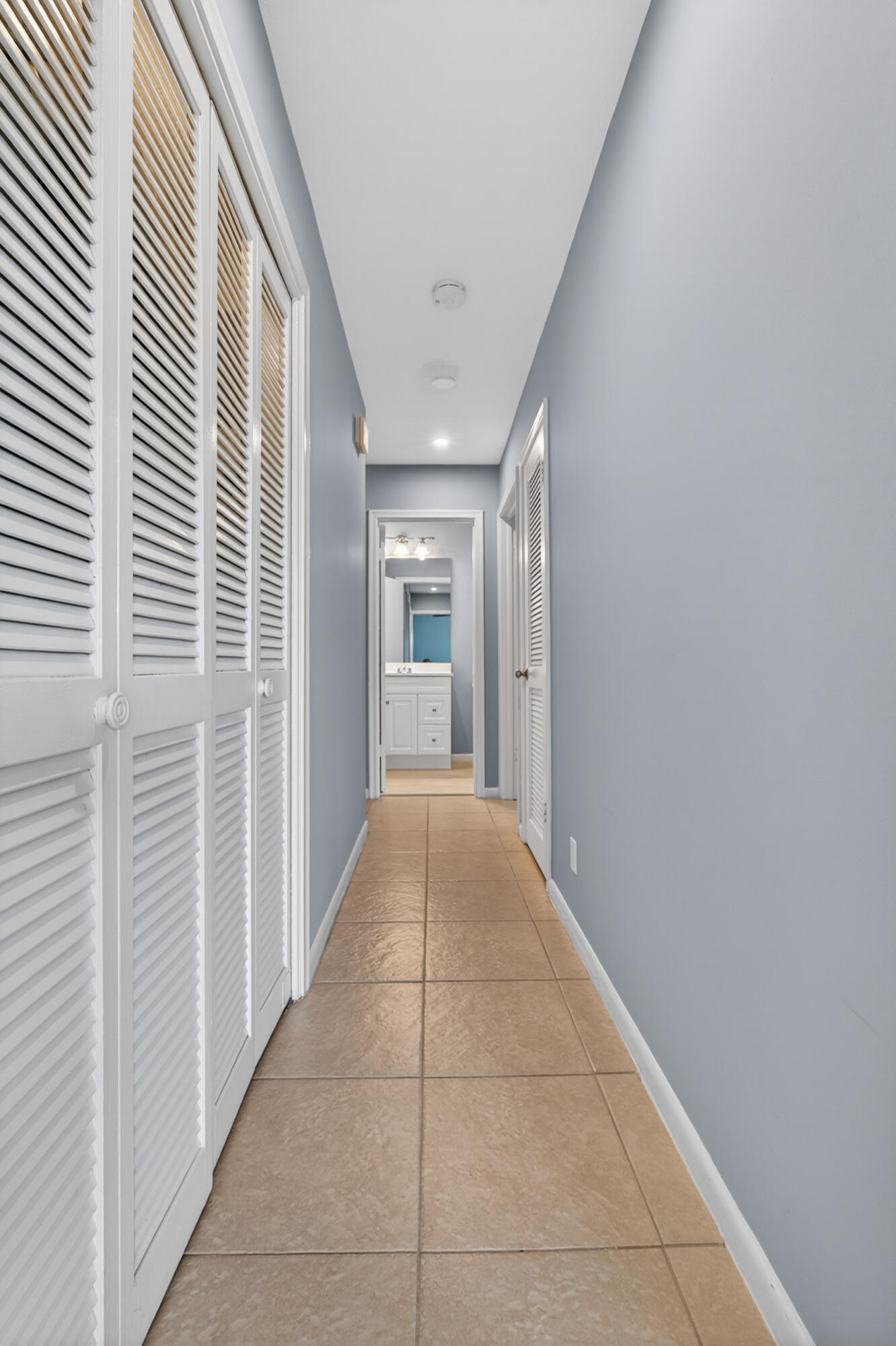 423 Pine Tree Court, Unit 23 Atlantis, FL 33462 - Photo 20 of 33 a view of a hallway with wooden floor and staircase