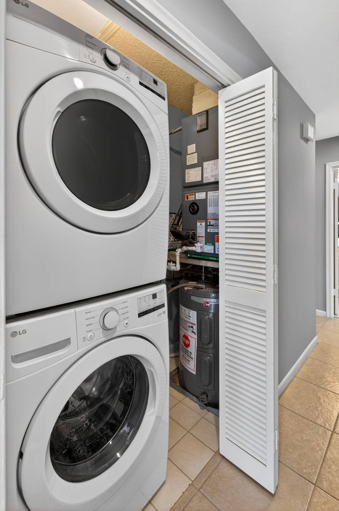 423 Pine Tree Court, Unit 23 Atlantis, FL 33462 - Photo 21 of 33 a utility room with dryer and washer
