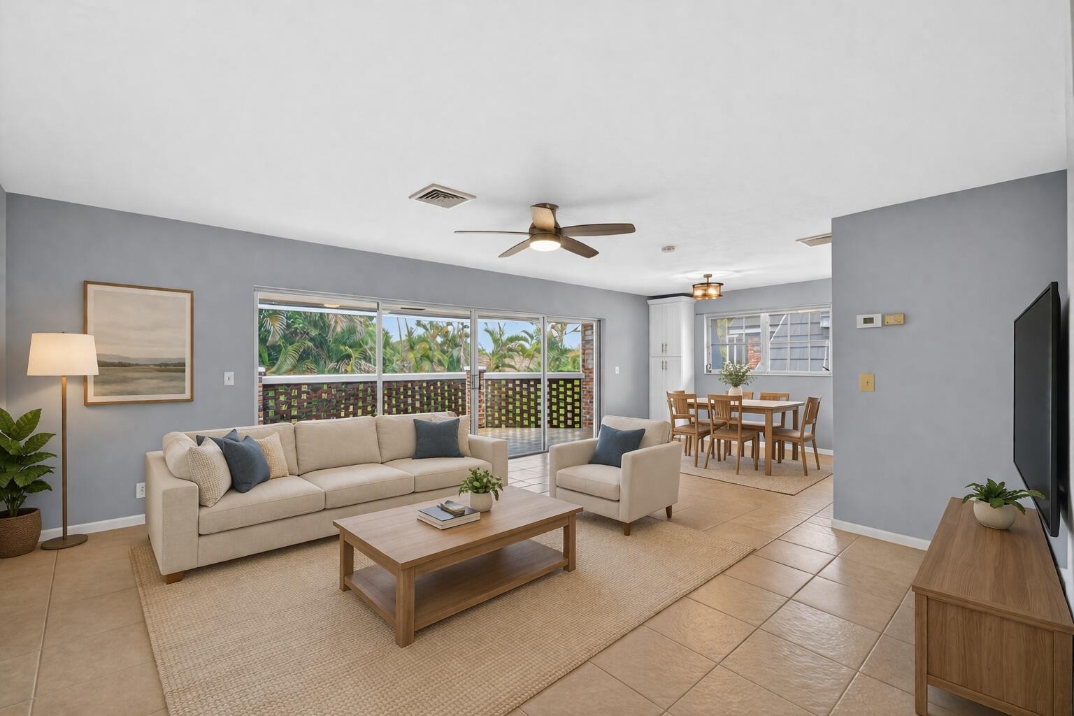 423 Pine Tree Court, Unit 23 Atlantis, FL 33462 - Photo 5 of 33 a living room with furniture and a flat screen tv
