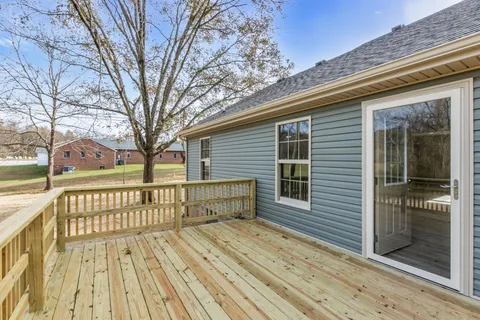 a view of a wooden deck with a yard