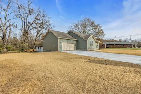 a house with swimming pool in front of it