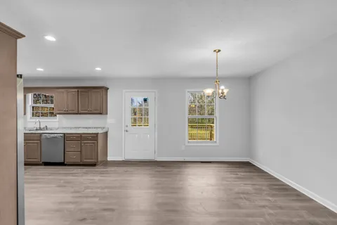 a kitchen with stainless steel appliances granite countertop a stove a sink and a refrigerator