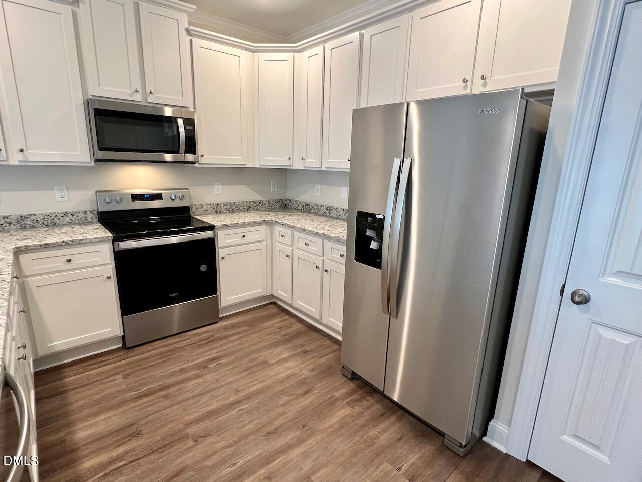 6905 Outfall Point Lane Raleigh, NC 27616 - Photo 12 of 44 a kitchen with stainless steel appliances granite countertop a refrigerator stove and sink