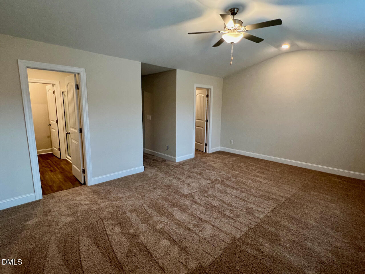 6905 Outfall Point Lane Raleigh, NC 27616 - Photo 13 of 44 a view of a bedroom with a ceiling fan and a bathroom