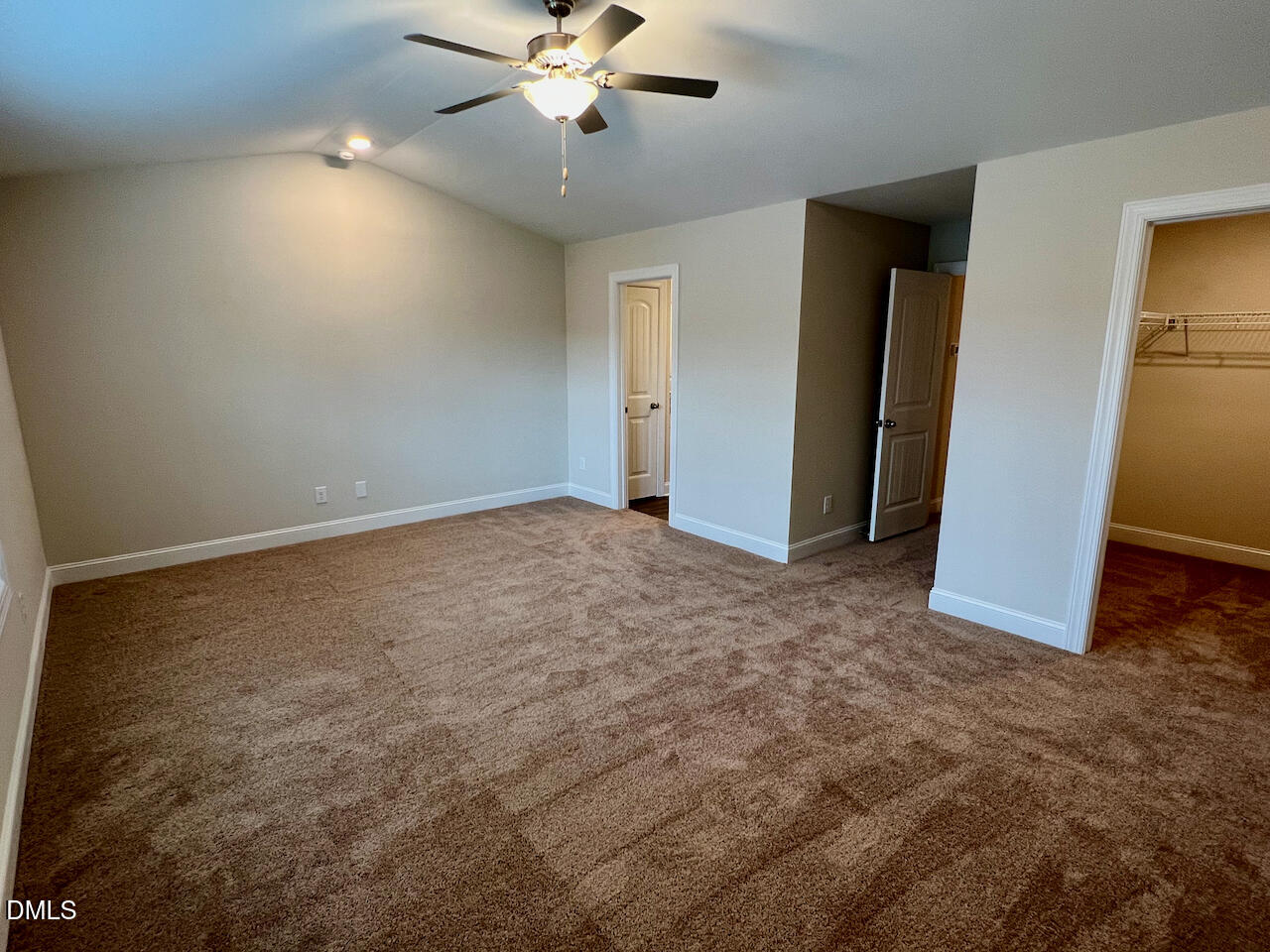 6905 Outfall Point Lane Raleigh, NC 27616 - Photo 14 of 44 an empty room with closet and fan