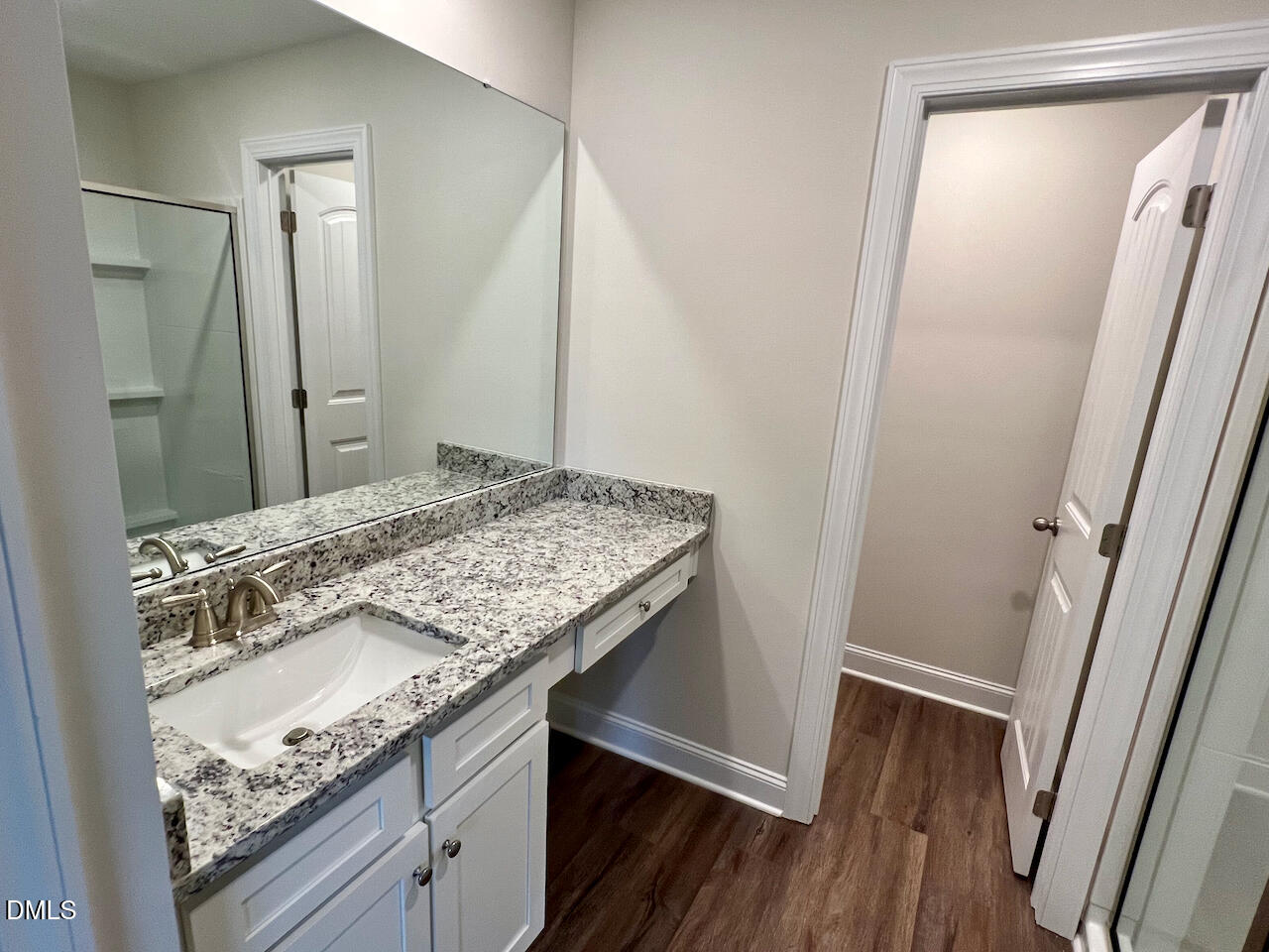 6905 Outfall Point Lane Raleigh, NC 27616 - Photo 19 of 44 a bathroom with a granite countertop sink and a mirror