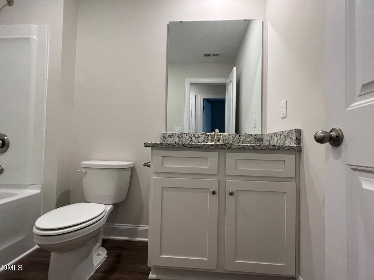 6905 Outfall Point Lane Raleigh, NC 27616 - Photo 30 of 44 a bathroom with a granite countertop toilet and sink