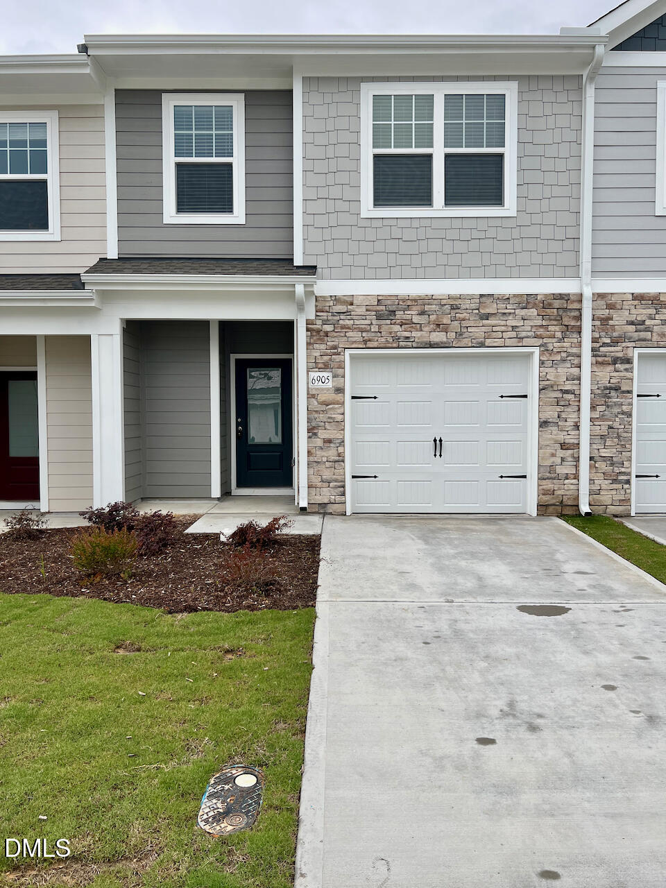 6905 Outfall Point Lane Raleigh, NC 27616 - Photo 3 of 44 a front view of a house with a garden