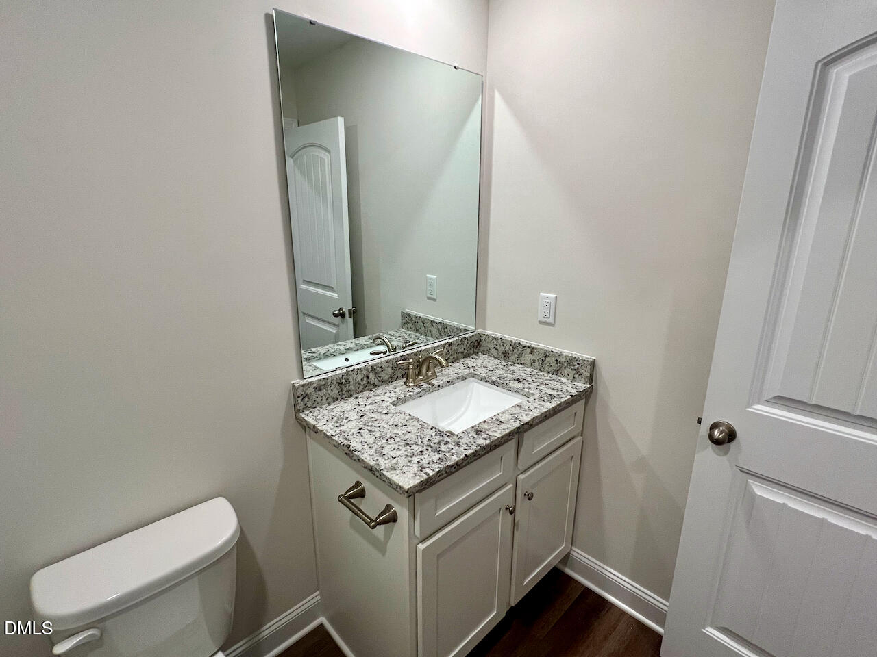 6905 Outfall Point Lane Raleigh, NC 27616 - Photo 32 of 44 a bathroom with a granite countertop sink and a toilet