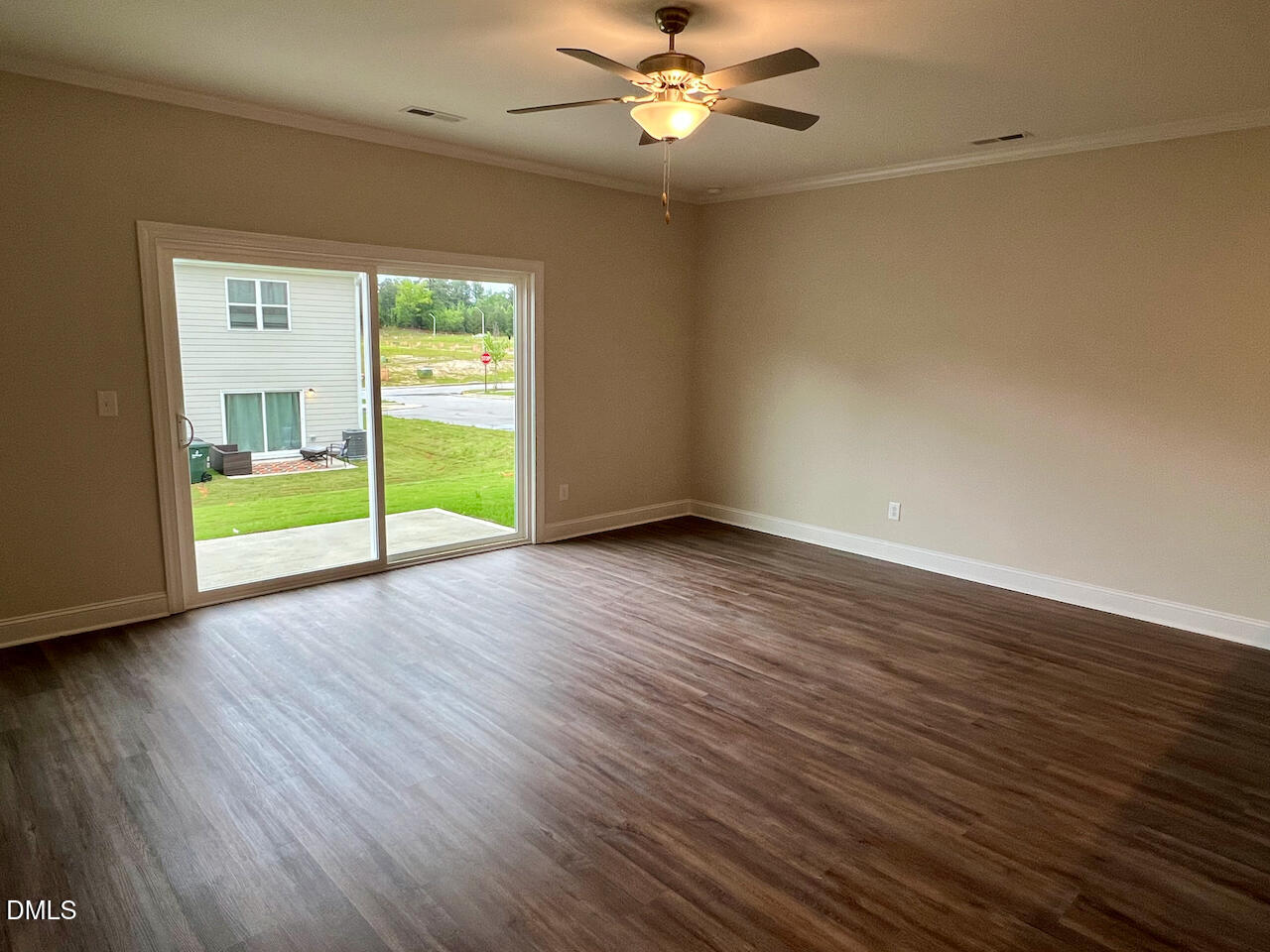 6905 Outfall Point Lane Raleigh, NC 27616 - Photo 9 of 44 an empty room with wooden floor fan and windows
