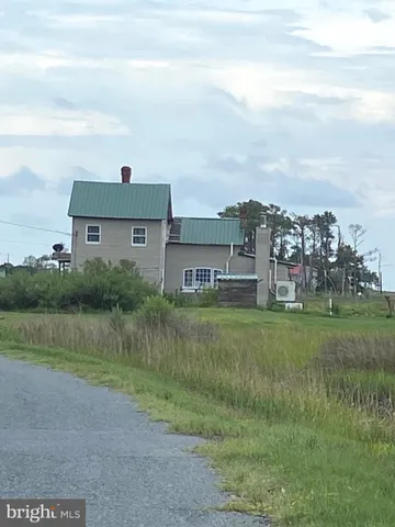 a view of a big house with a big yard and large trees