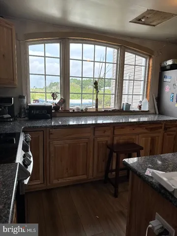 a kitchen with a sink a window and cabinets