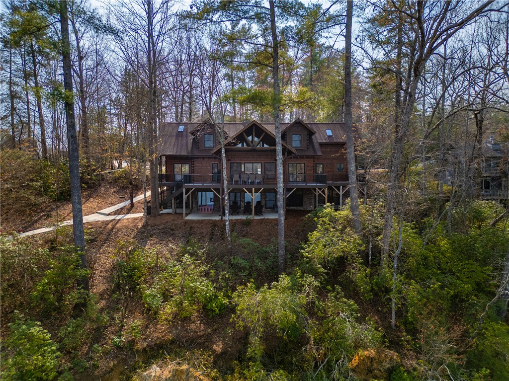 This charming home features spacious deck/patio overlooking the lush, natural landscape, mountain views and Lake Keowee.