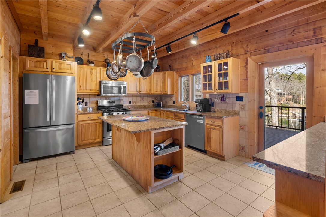109 Deer Laurel Way Salem, SC 29676 - Photo 12 of 50 This warm kitchen features rustic wood finishes and direct access to an outdoor deck.
