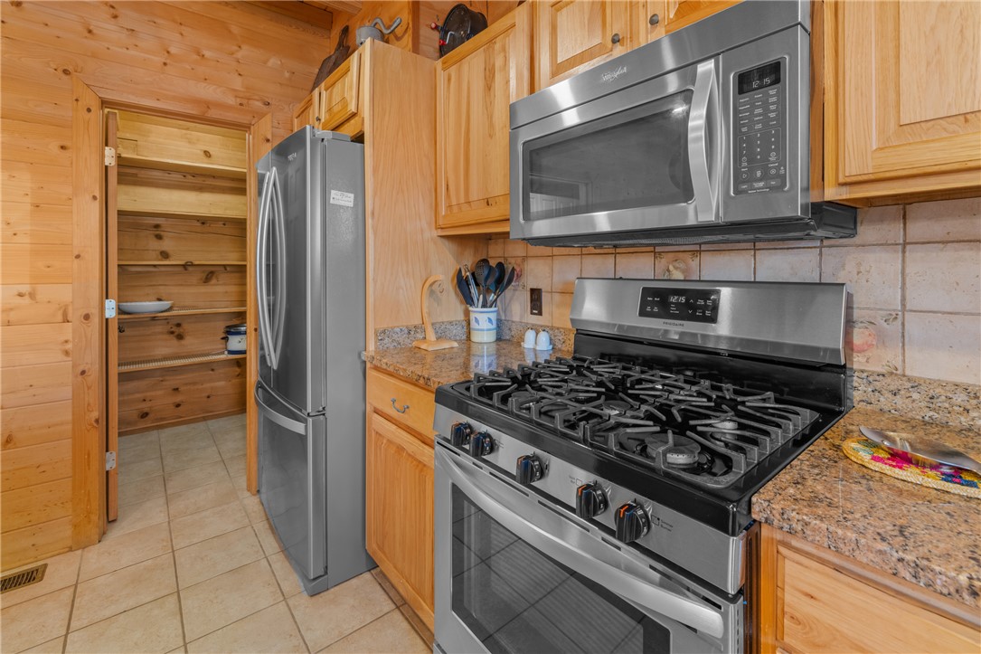 109 Deer Laurel Way Salem, SC 29676 - Photo 16 of 50 This cozy kitchen features robust wooden cabinetry and modern stainless steel appliances.