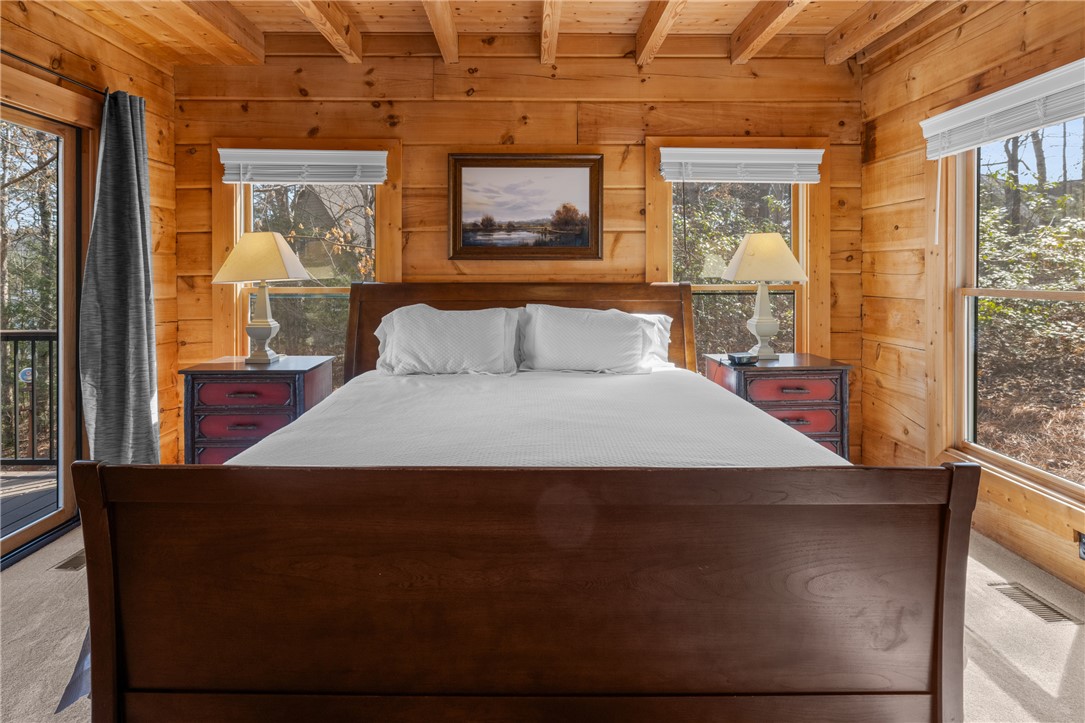 109 Deer Laurel Way Salem, SC 29676 - Photo 19 of 50 Warm wood tones and large windows create a bright and inviting bedroom retreat.