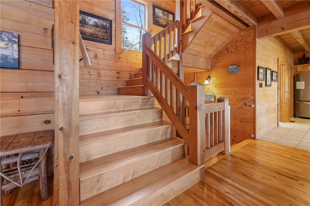 109 Deer Laurel Way Salem, SC 29676 - Photo 21 of 50 This interior showcases a warm, inviting staircase with rich wood finishes, creating a harmonious living space.