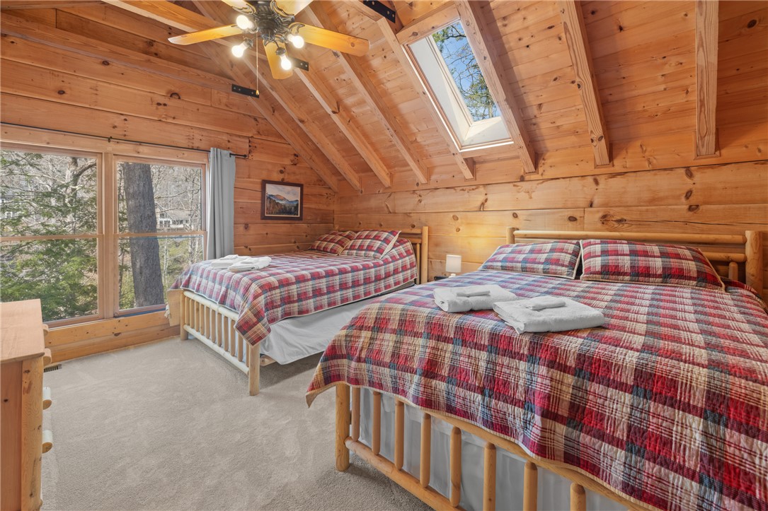 109 Deer Laurel Way Salem, SC 29676 - Photo 22 of 50 Warm and inviting cabin bedroom with ensuite full bath, natural wood finishes and abundant light.