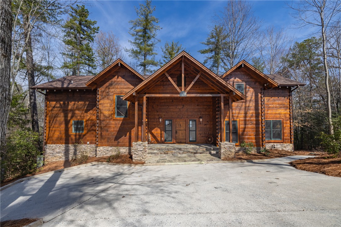 109 Deer Laurel Way Salem, SC 29676 - Photo 4 of 50 This grand lodge retreat features a welcoming stone facade and a rustic timber-framed entrance.