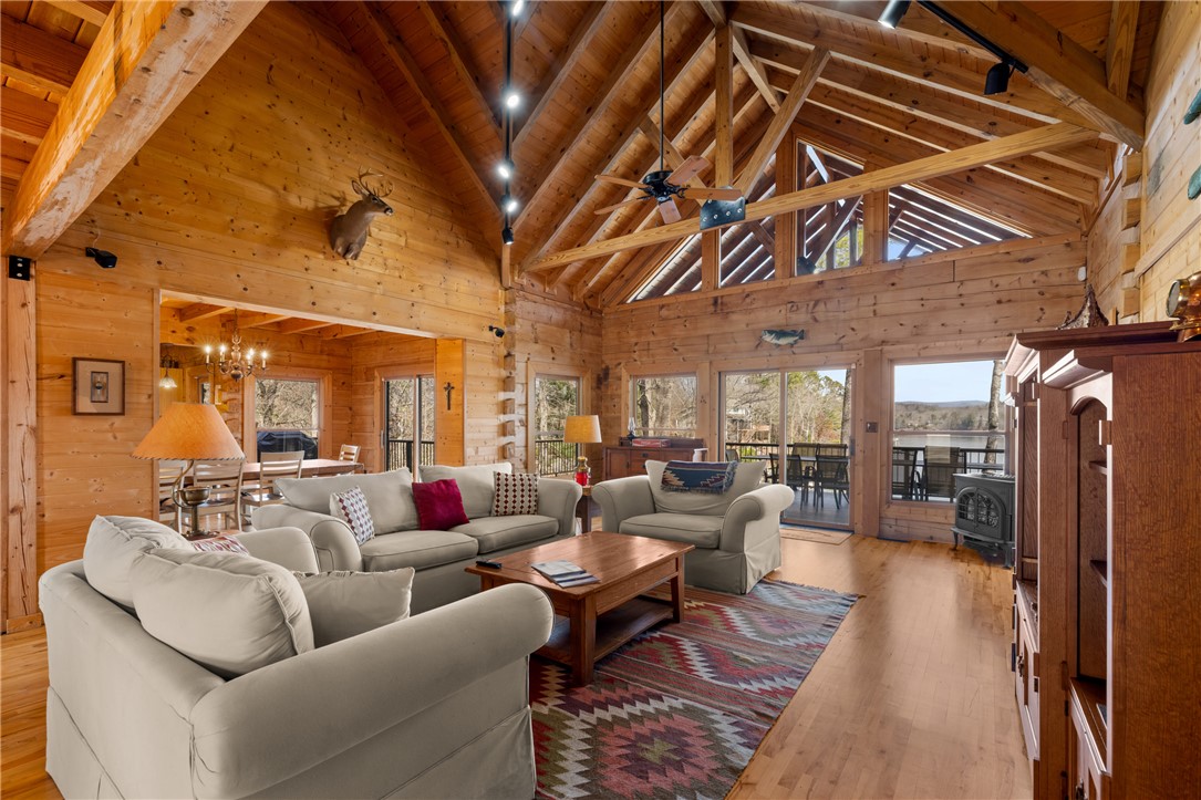 109 Deer Laurel Way Salem, SC 29676 - Photo 5 of 50 This expansive living space features high ceilings, hardwood flooring, and ample natural light with water views.