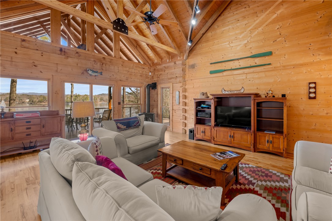 109 Deer Laurel Way Salem, SC 29676 - Photo 6 of 50 This living room features vaulted wood ceilings, large windows, and a breathtaking lake view.