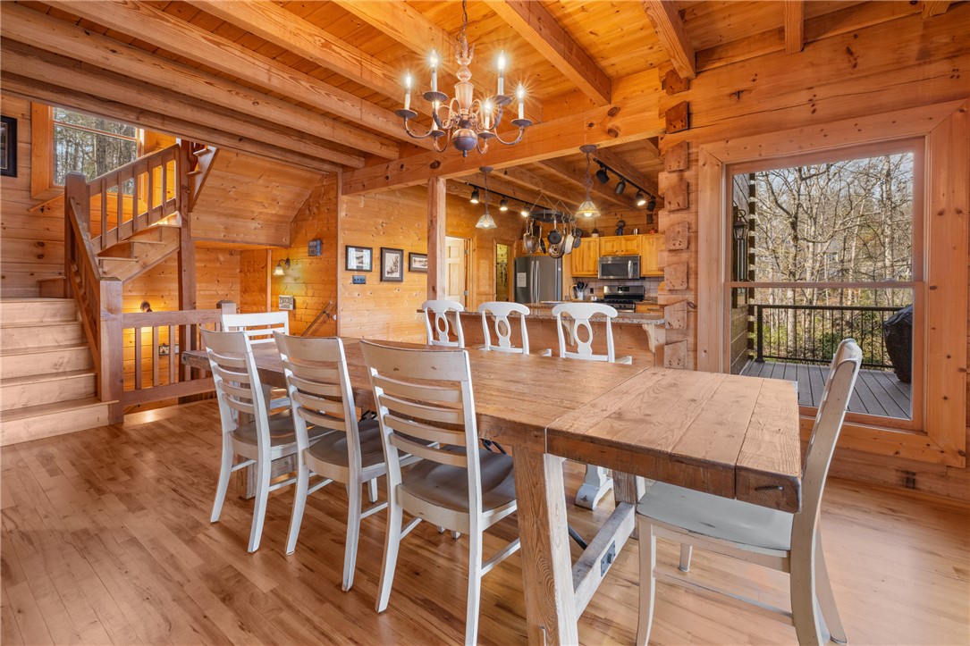 109 Deer Laurel Way Salem, SC 29676 - Photo 9 of 50 This expansive space showcases high ceilings, hardwood flooring, and a kitchen island with views of the outdoors.