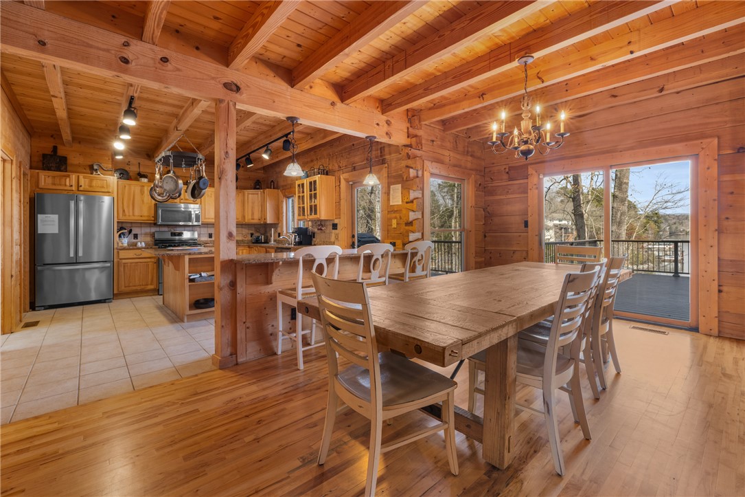 109 Deer Laurel Way Salem, SC 29676 - Photo 10 of 50 This inviting dining area seamlessly connects to the kitchen, offering expansive views and hardwood floors.