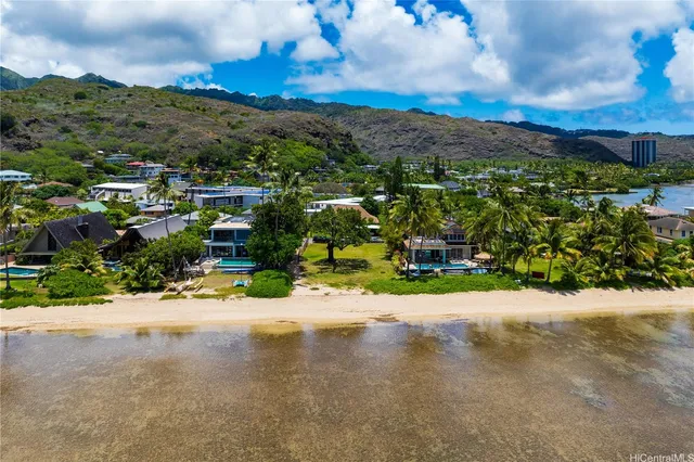 an aerial view of residential houses with outdoor space and street view