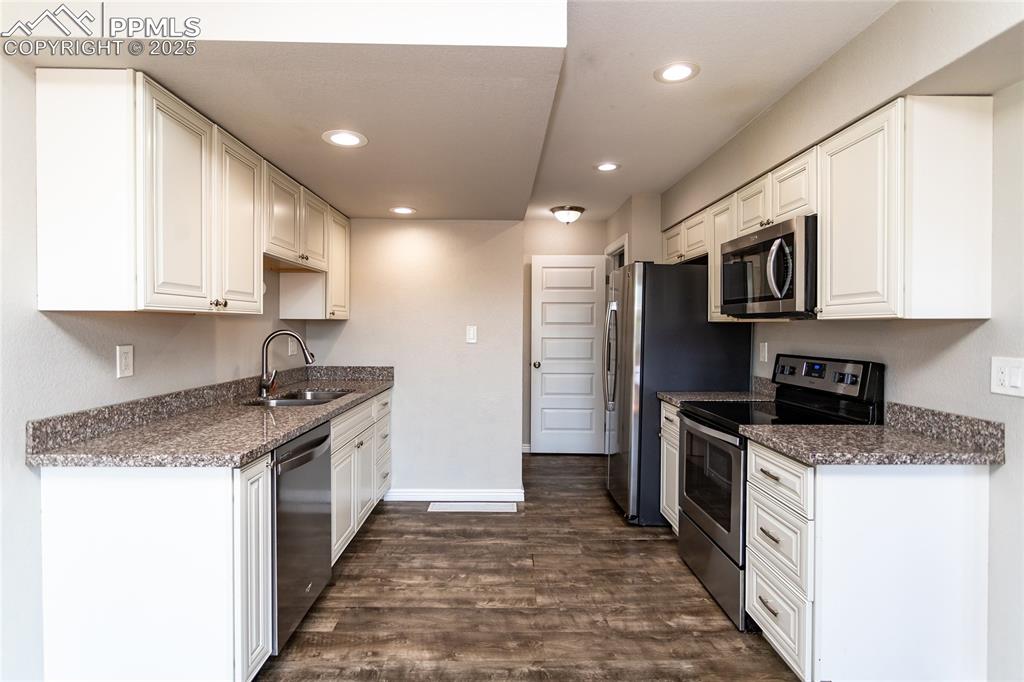 4505 Lamplighter Circle Colorado Springs, CO 80916 - Photo 15 of 39 a kitchen with stainless steel appliances granite countertop a stove top oven a sink and dishwasher