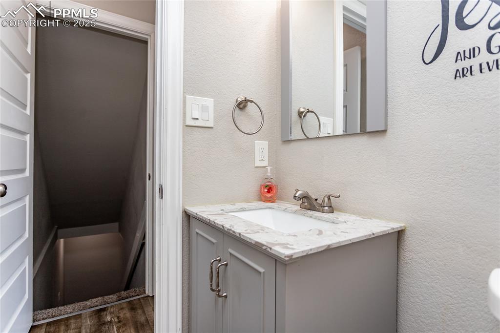 4505 Lamplighter Circle Colorado Springs, CO 80916 - Photo 20 of 39 a bathroom with a granite countertop sink and a mirror