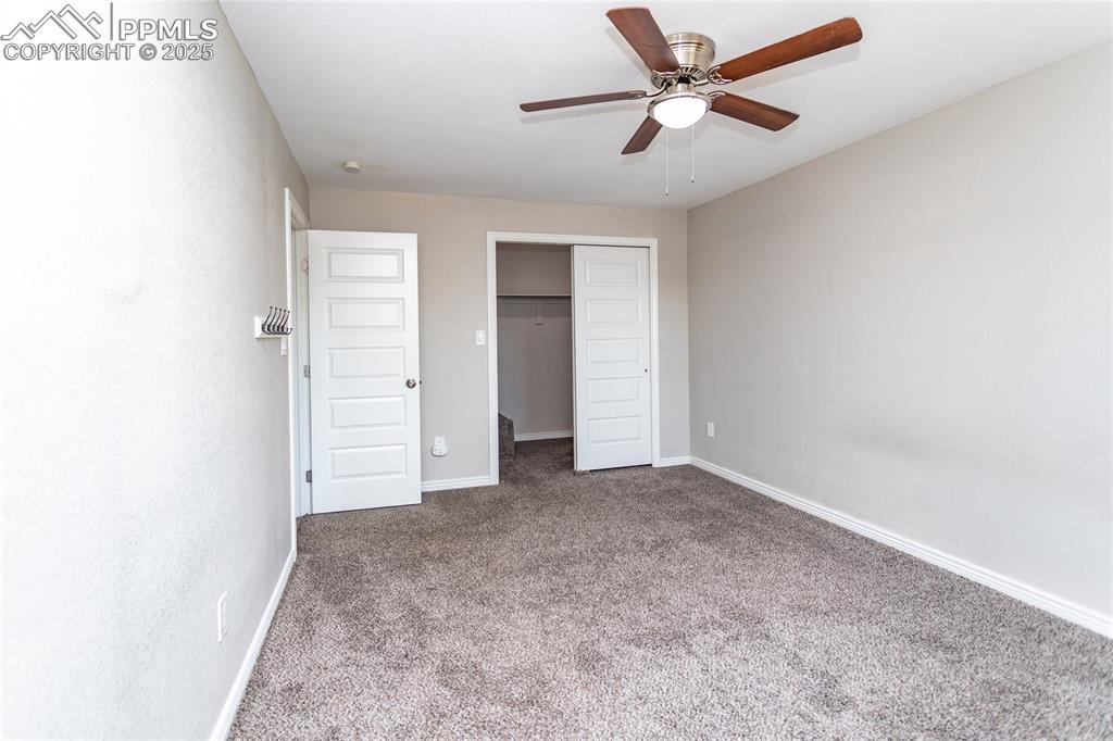 4505 Lamplighter Circle Colorado Springs, CO 80916 - Photo 23 of 39 an empty room with closet and a ceiling fan