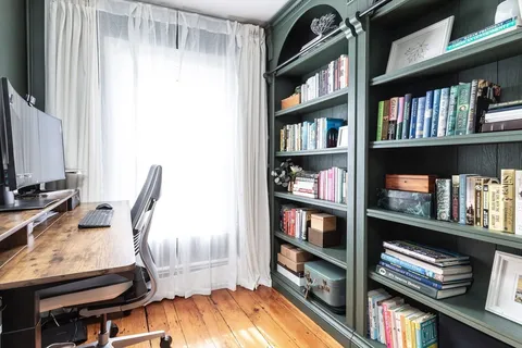 a view of a workspace with bookshelf