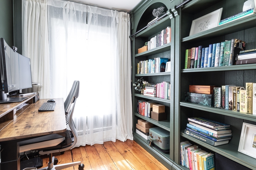 27 St James Street Boston, MA 02119 - Photo 13 of 26 a view of a workspace with bookshelf