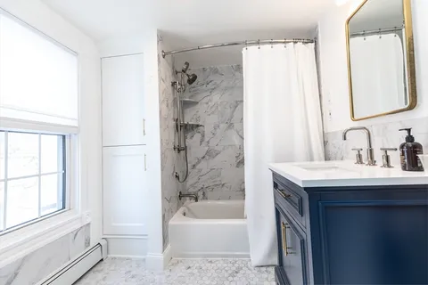 a bathroom with a bathtub and a sink