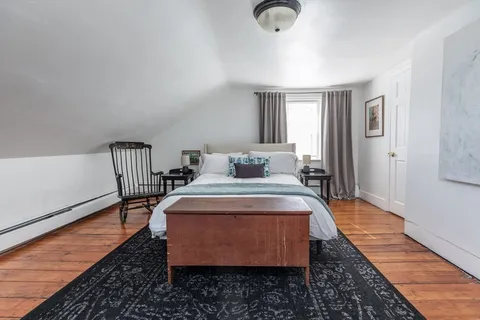 a bedroom with bed and a window
